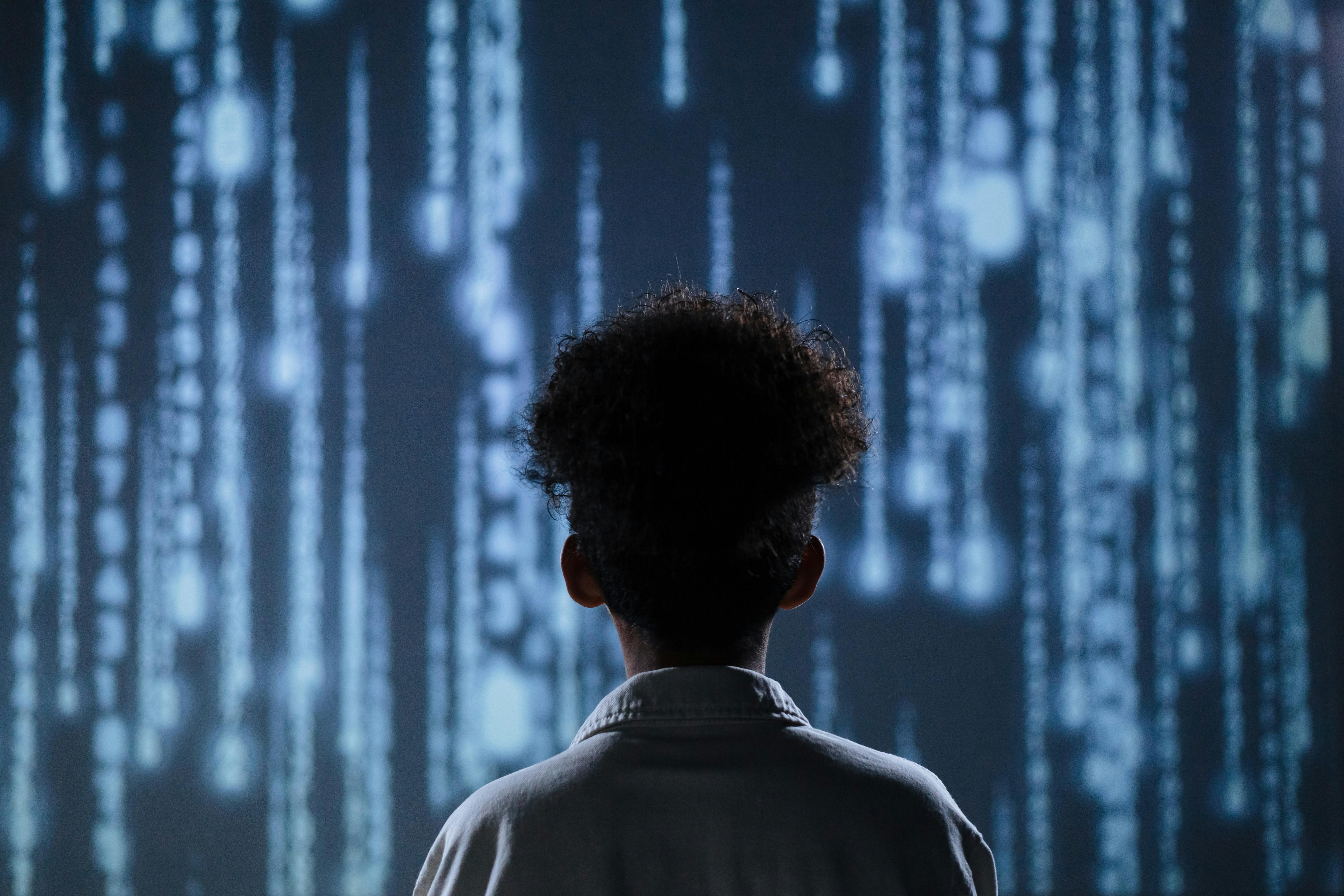 a womman looking at a tech screen